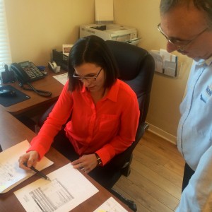 Doug Close and Karen George reviewing documents together.