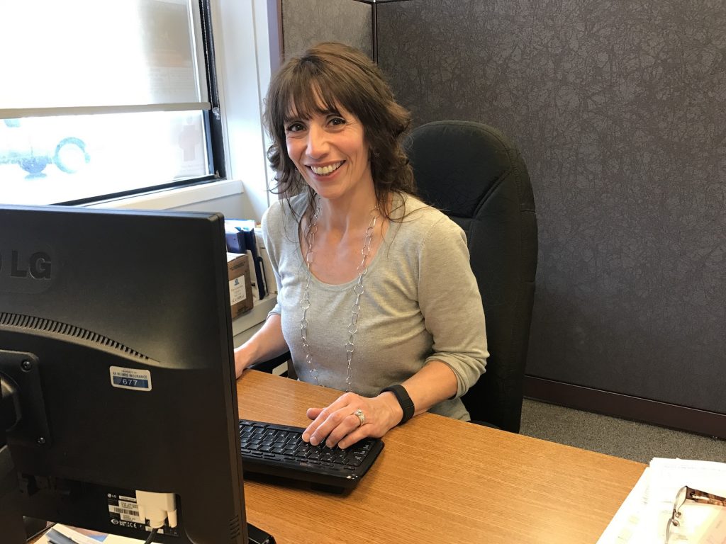 Michelle Green at her desk, AA Munro Insurance Turo location