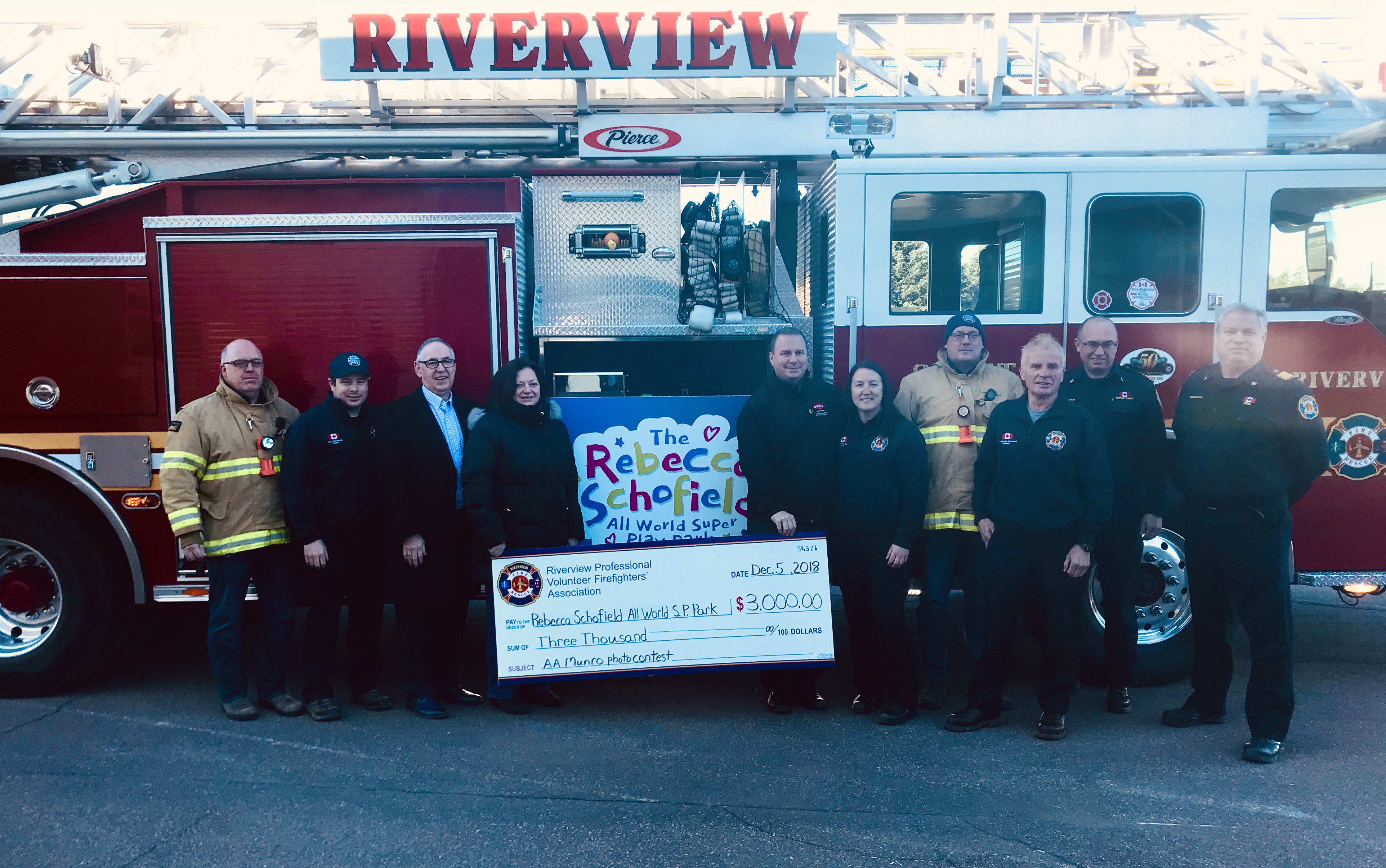 Firefighters in Riverview, New Brunswick gather with Anne Schofield and Wayne Ezekiel