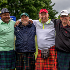 Wayne Ezekiel in a kilt with friends