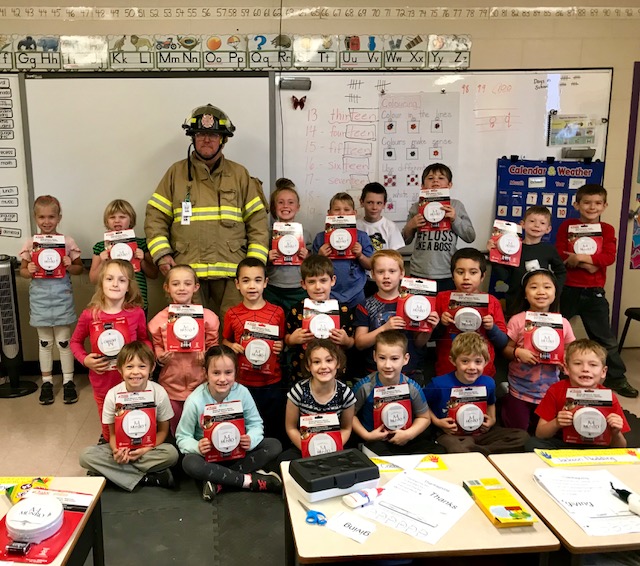 Firefighter in gear with children