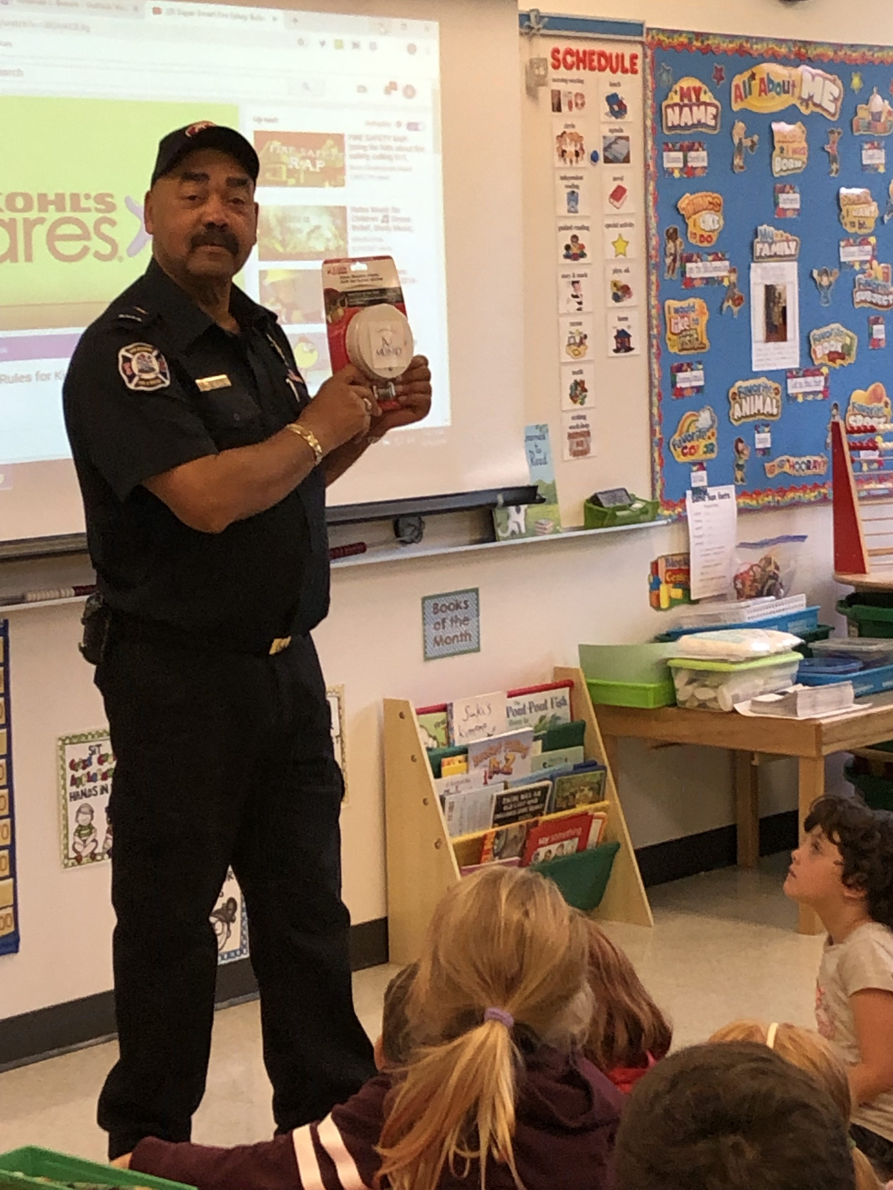 Firefighter explaining a smoke detector